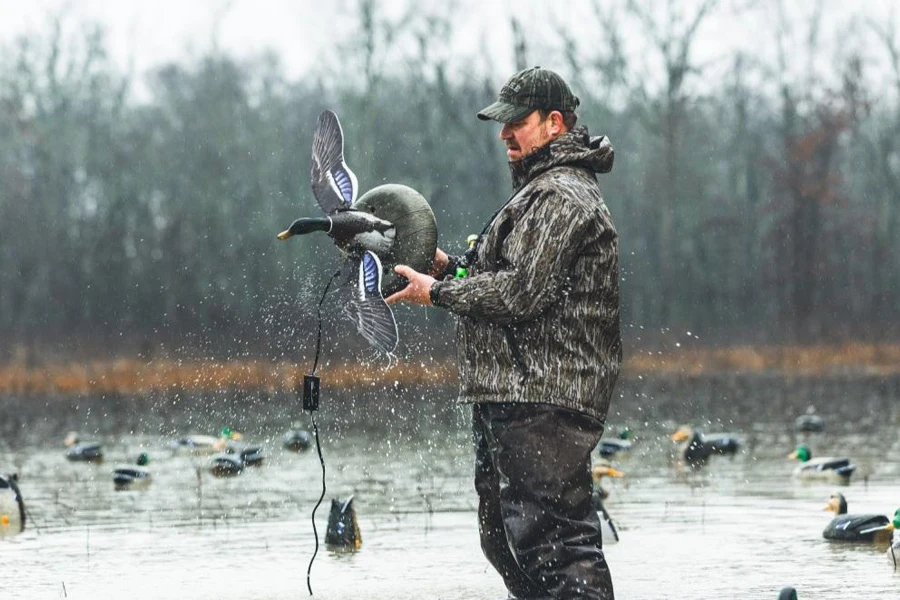 A hunter setting up a duck decoy spread