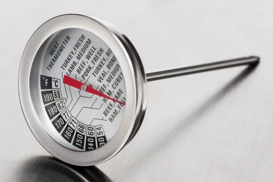 A kitchen thermometer with a round display