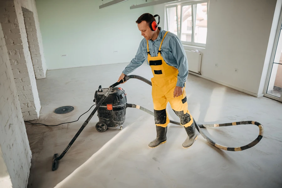 A male worker cleaning a construction site