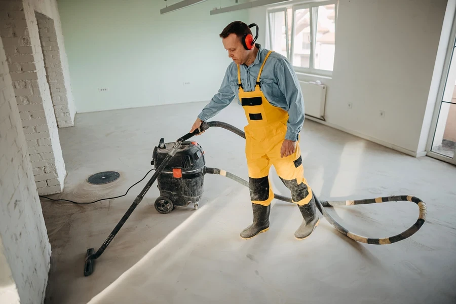 A male worker cleaning a construction site