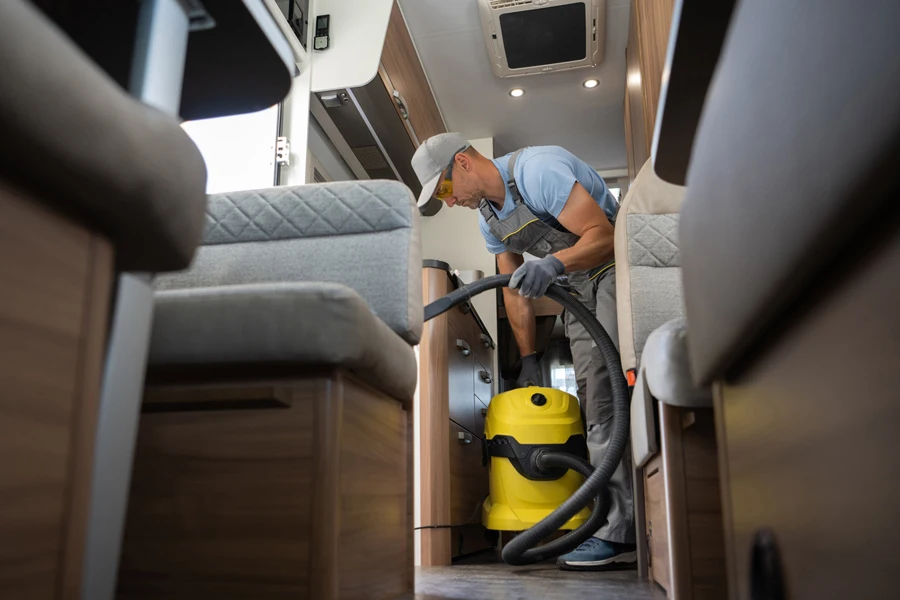 A man cleaning a camper van interior