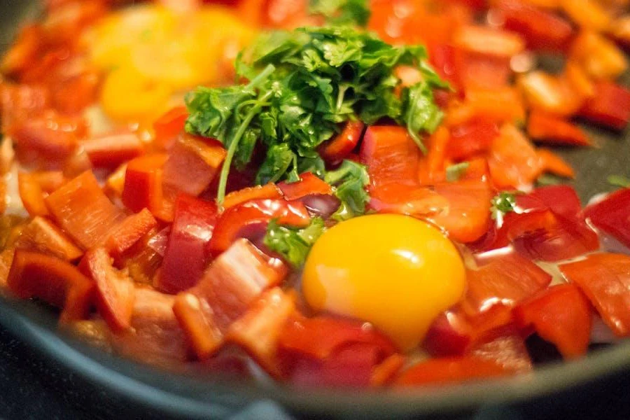 A non-stick pan with food cooking in it