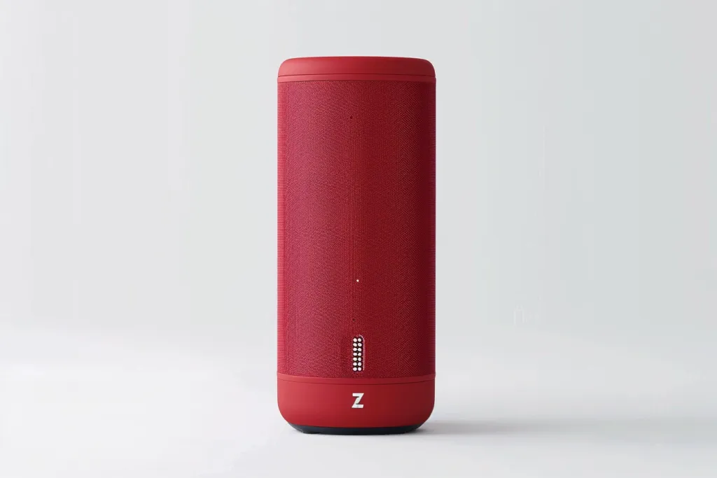 A red cylindrical speaker with rounded edges