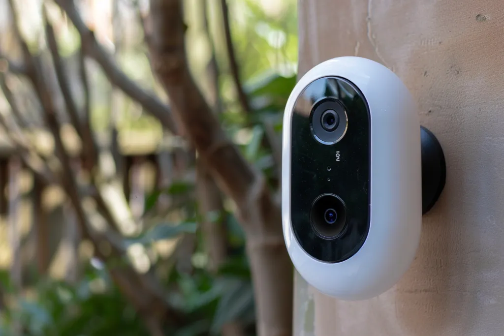 A simple white plastic doorbell camera in the style of product design