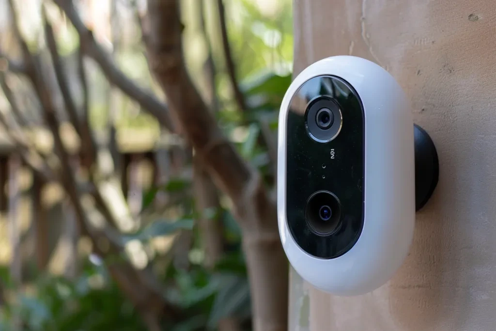 A simple white plastic doorbell camera in the style of product design