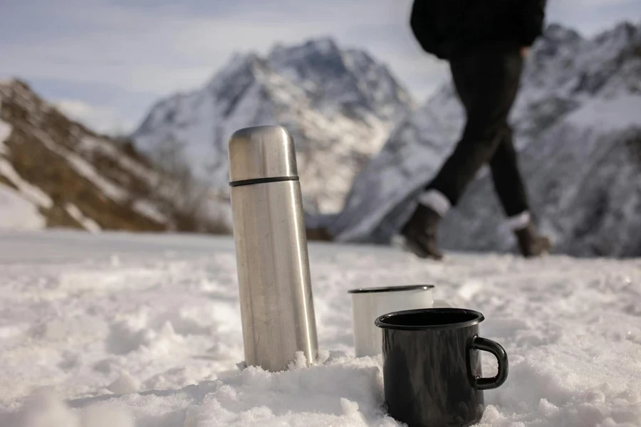 A standard vacuum flask with two metal cups