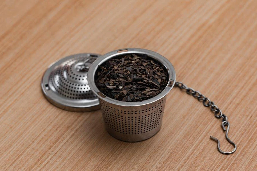 A tea infuser basket packed with tea leaves