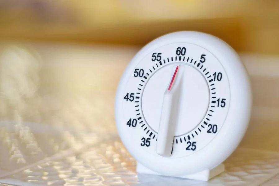 A white kitchen timer placed on a platform