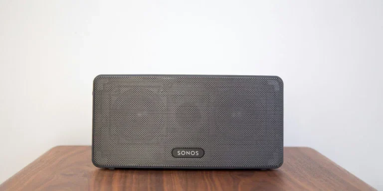 Black Bluetooth Speaker on Wooden Table