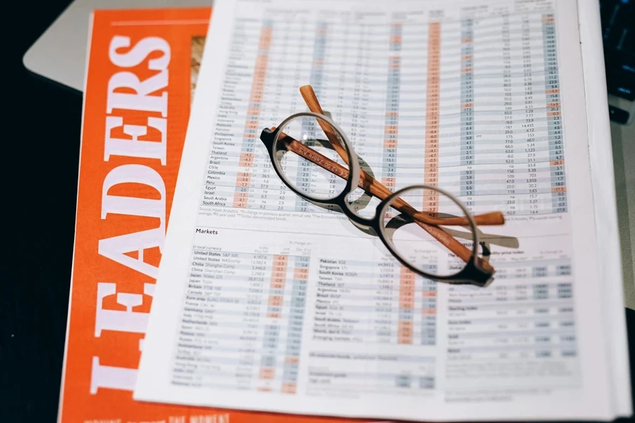 Black Framed Eyeglasses on White and Orange Paper