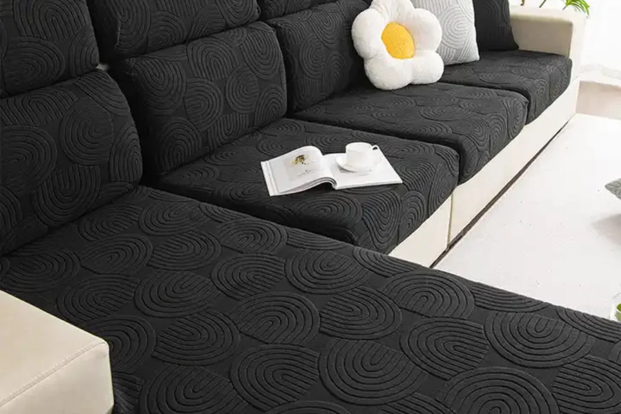 Black patterned couch slipcover on large L-shaped sofa