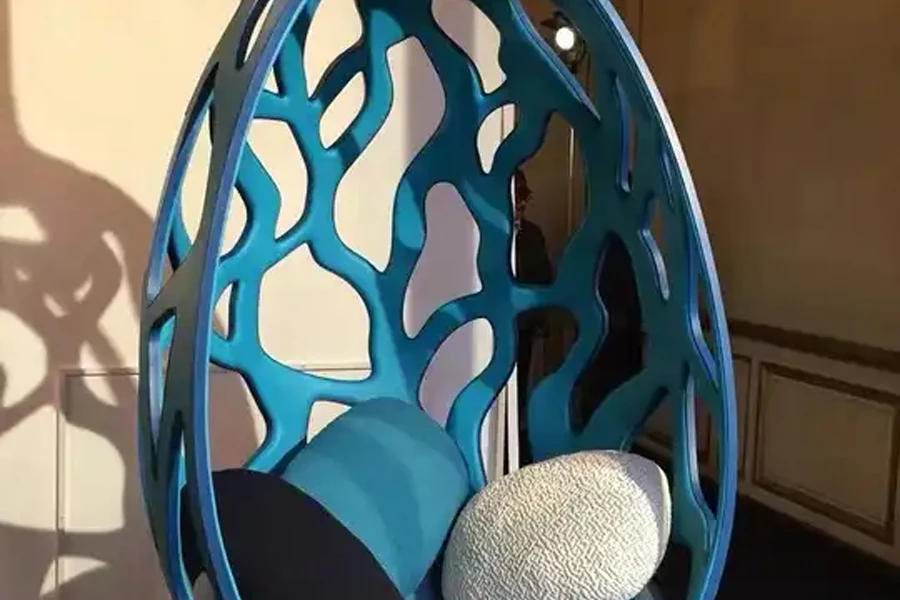 Blue cut-out hanging fiberglass pod chair