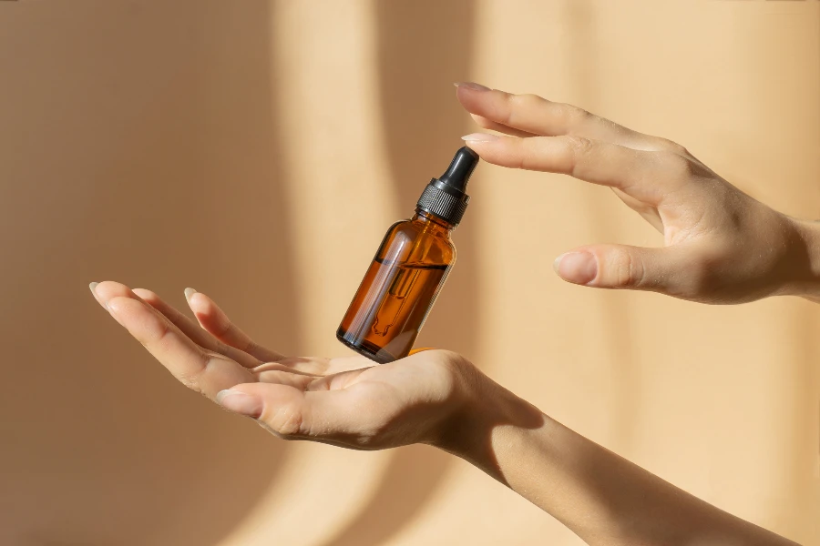 Bottle of serum in women's hands