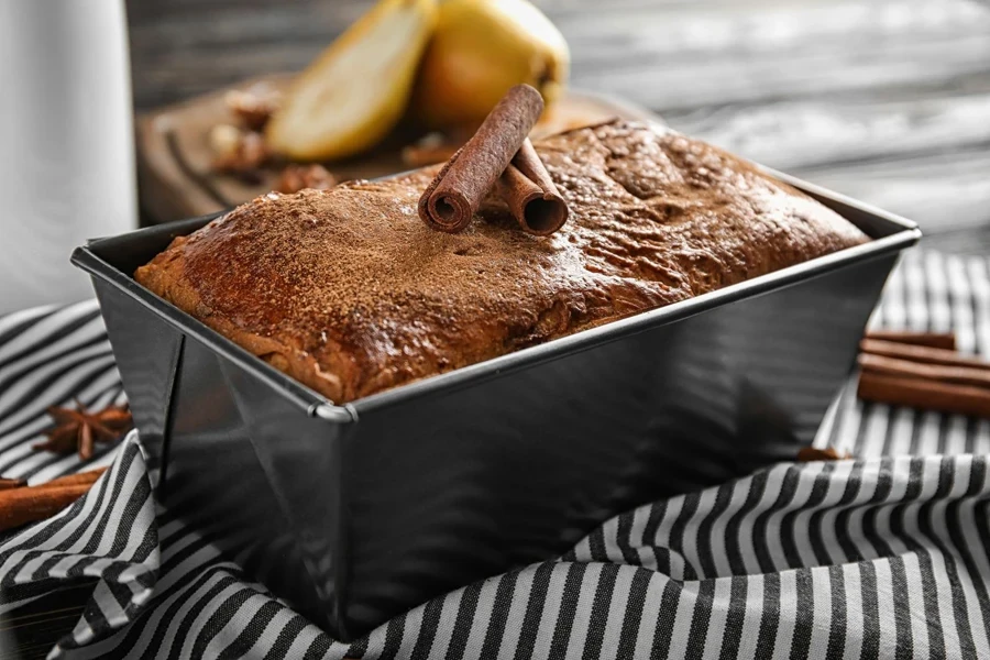 Bread baked in stainless steel pan with cinnamon sticks