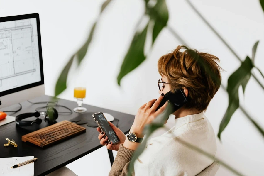 Businesswoman making a call and sending messages