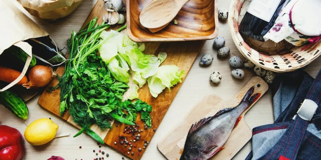 Chopping boards with vegetables and fish