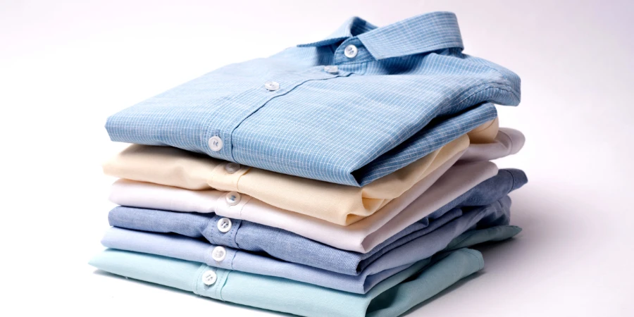 Classic men's shirts stacked on white background