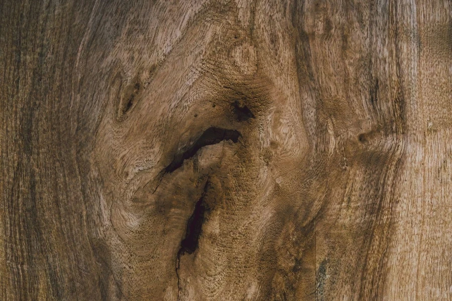 Close-up of Wood Grain With Hole, Showcasing Natural Textures and Patterns