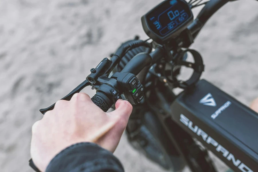 Close-up of a Man Holding the Handlebar of an Electric Bike