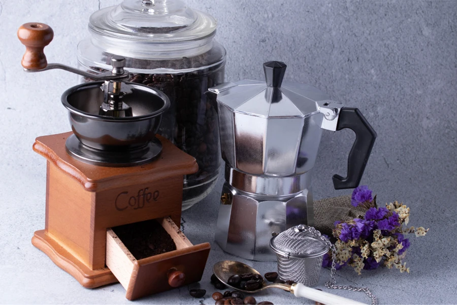 Coffee grinder beside a coffee percolator