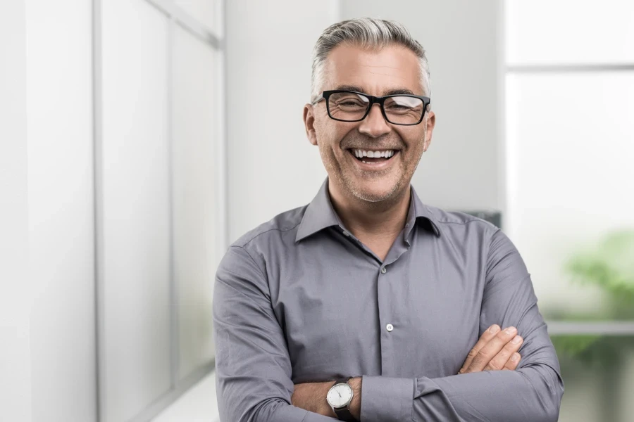 Confident businessman posing in the office with arms crossed