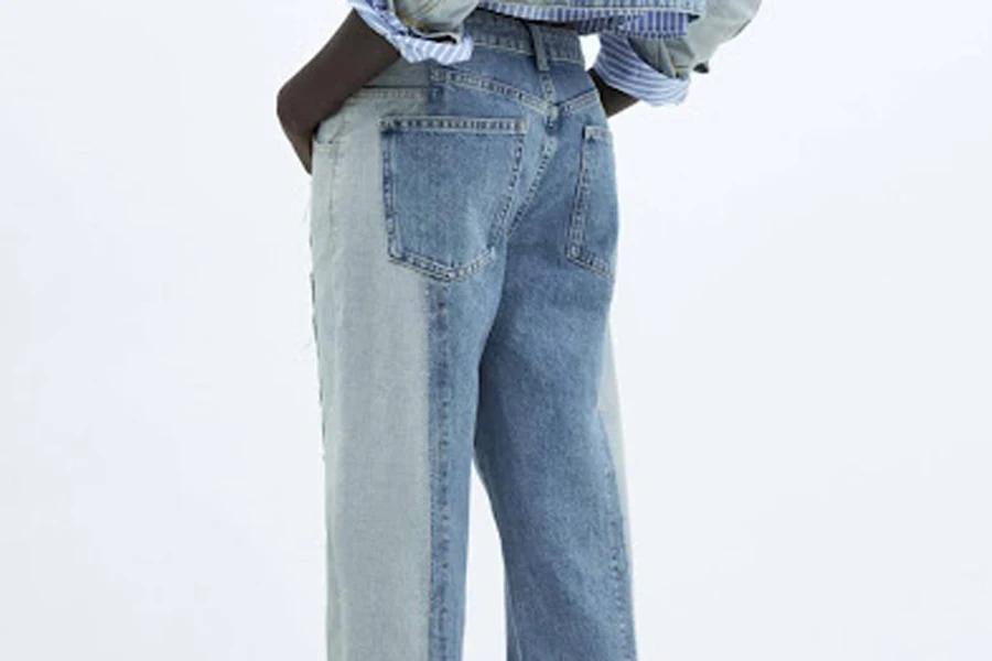Dark-skinned lady showing her back in two-tone straight jeans