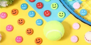 Different colors of tennis dampeners with smiley faces