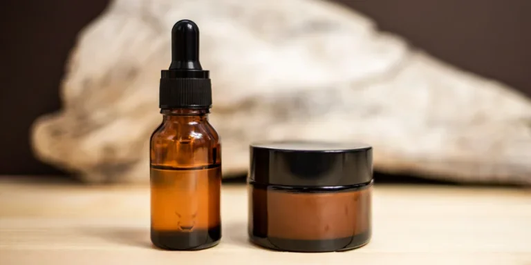 Glass bottles for cosmetics on a beige background