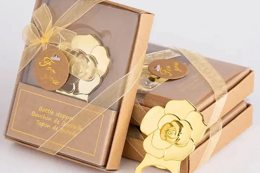 Gold bottle opener in rose shape on gift boxes
