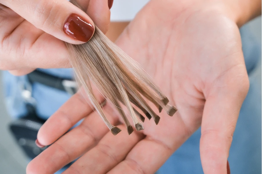 Hair strands with capsules in hand