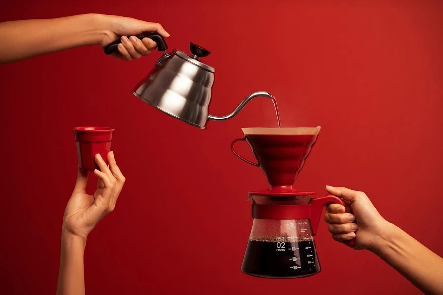 Hand pouring water into a coffee filter