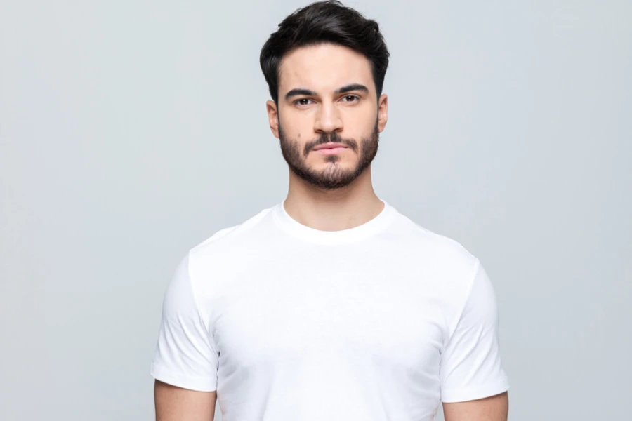 Handsome man wearing white t-shirt looking at camera