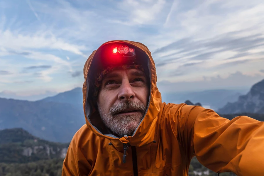 Hiker with rain jacket and headlamp