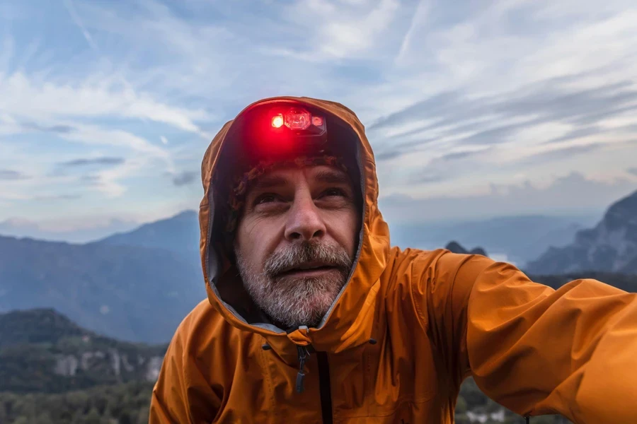 Hiker with rain jacket and headlamp