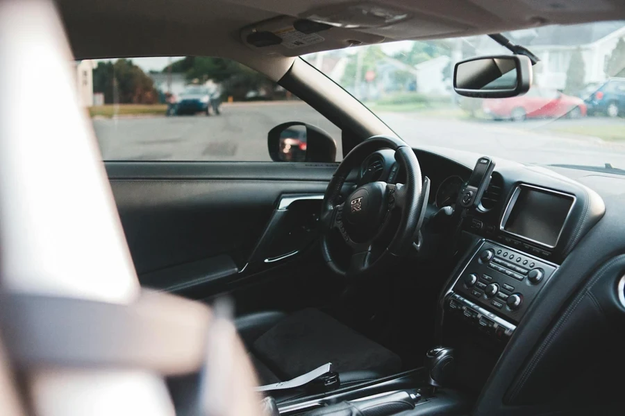 Interior of contemporary car with leather seats and modern dashboard near stylish steering wheel in daylight