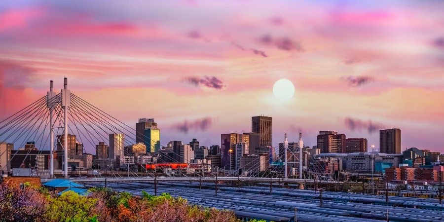 Skyline von Johannesburg und Nelson-Mandela-Brücke bei Sonnenuntergang