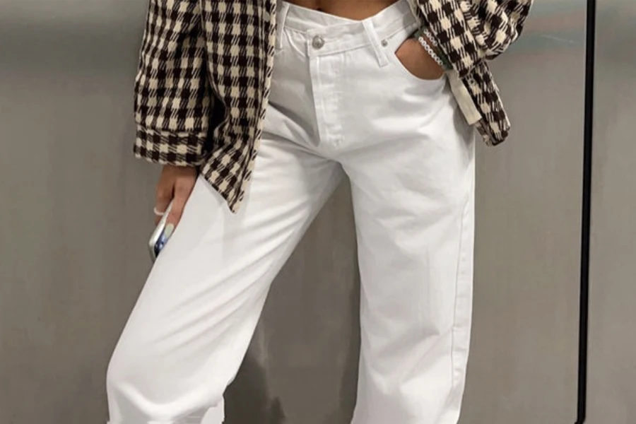 Lady wearing a checkered shirt and white straight jeans