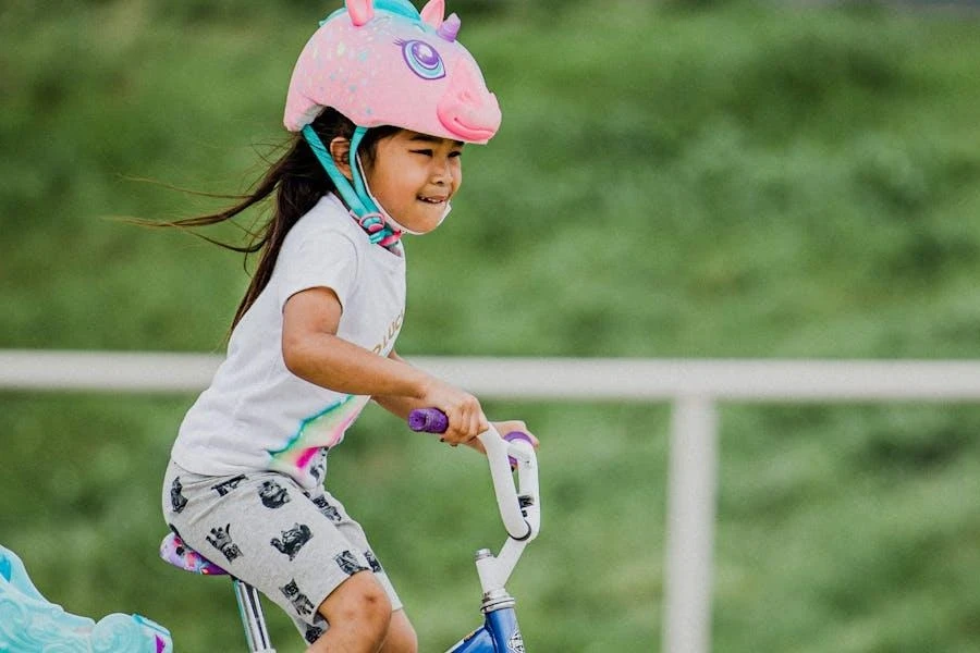 Little girl wearing a pink unicorn helmet