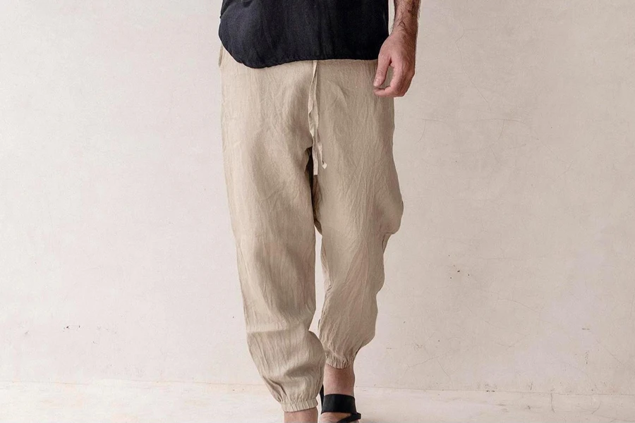 Man in black sandals and linen joggers