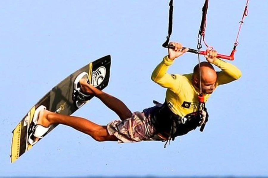 Man in the air while firmly attached to a kitesurfing board