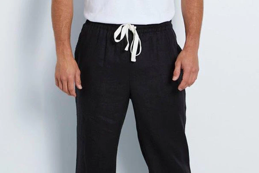 Man posing in a black drawstring linen pant