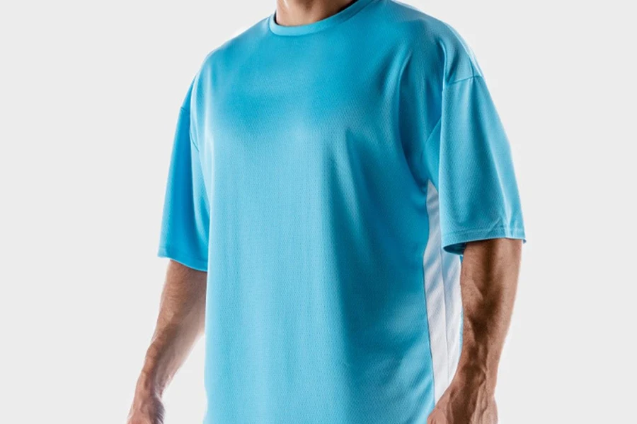Man posing in a blue oversized mixed-material shirt