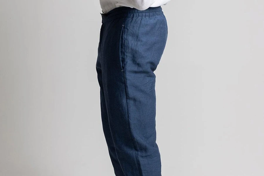Man posing sideways in sustainable linen pants