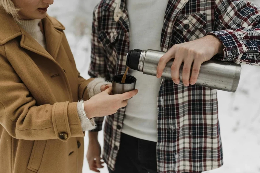 Man pouring coffee out from a vacuum flask