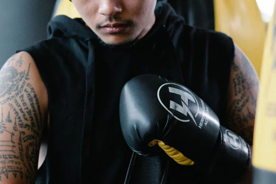 Man preparing for a workout in a black hooded vest