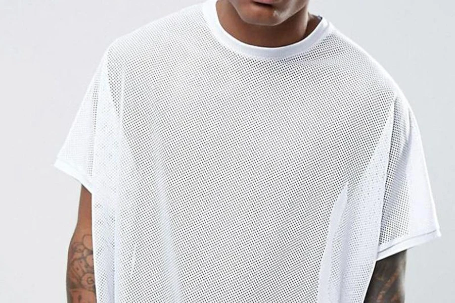 Man rocking a white oversized mesh shirt