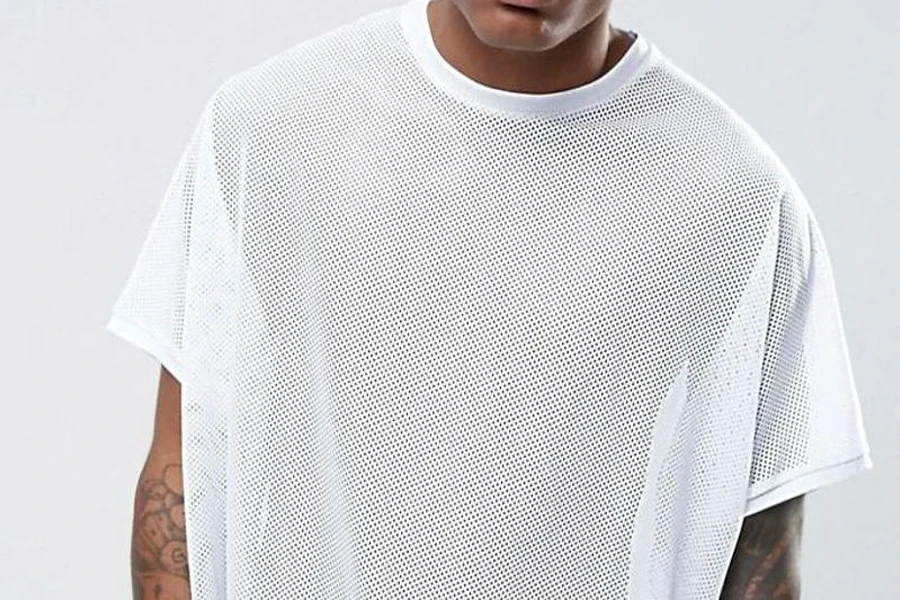 Man rocking a white oversized mesh shirt