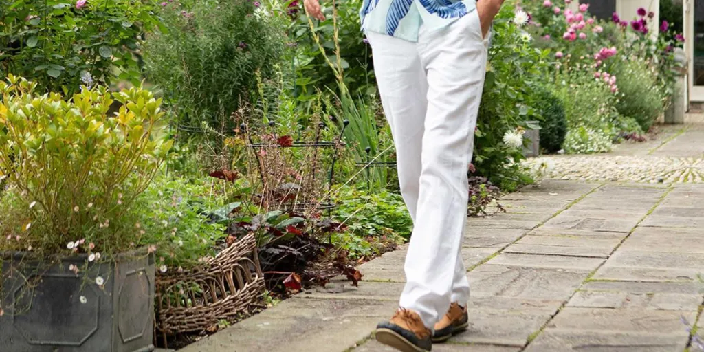 Man walking confidently in white linen pants