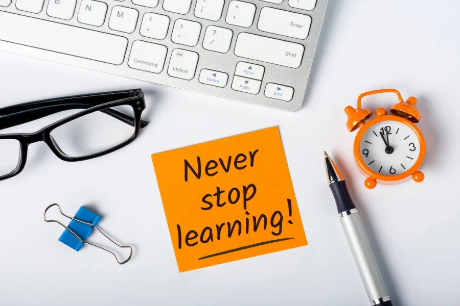 Never stop Learning - written message on white desk workplace