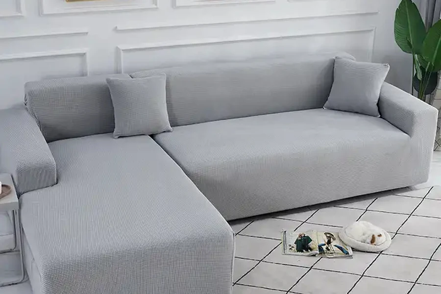 Pale gray couch slipcover fitted on L-shaped sofa